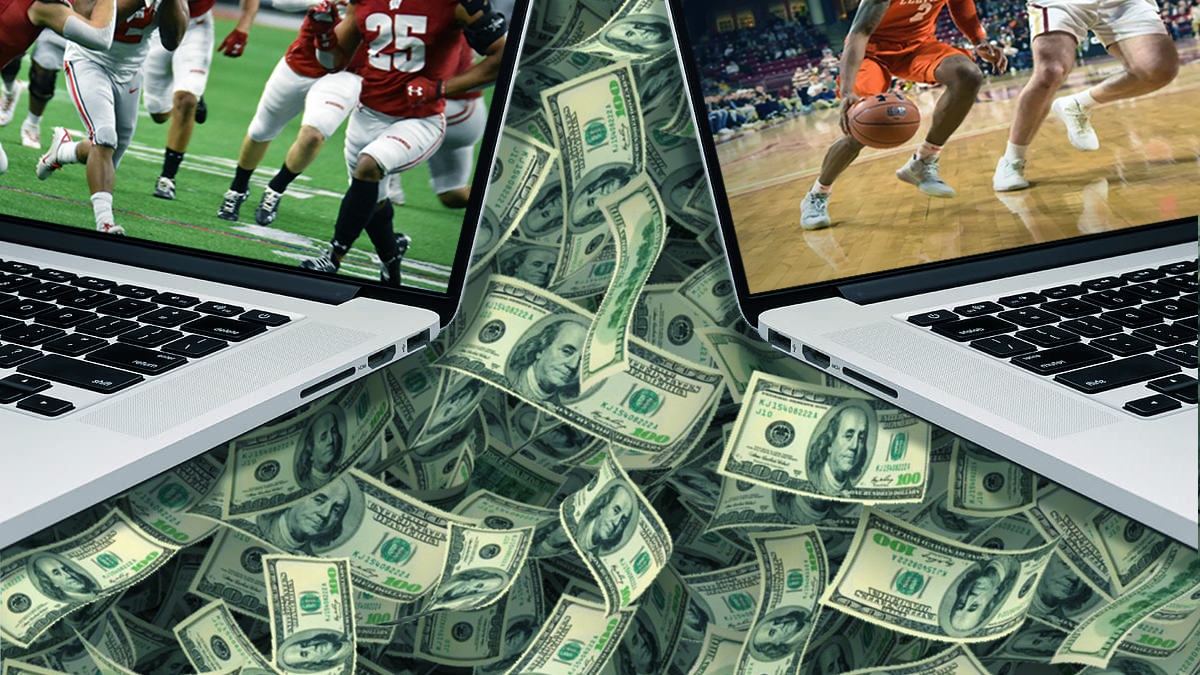 Two Laptops Showing Sports in Front of a Pile of Money