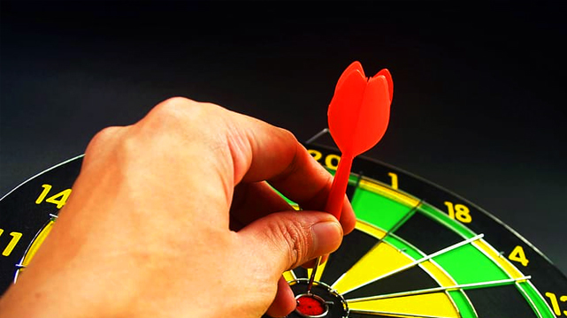 Hand Grabbing Dart From a Dart Board