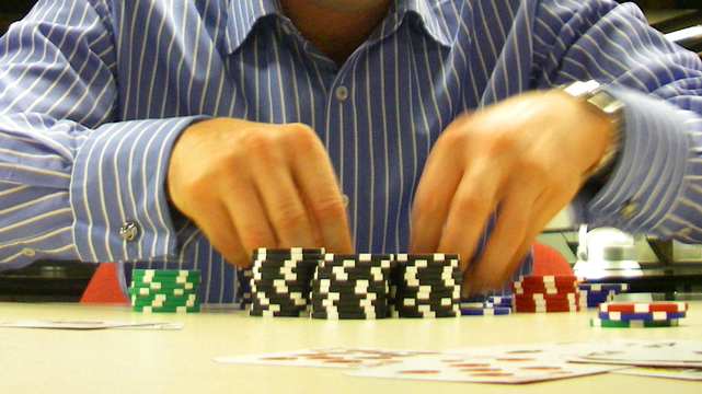 Closeup of a Poker Players Hands and Chips