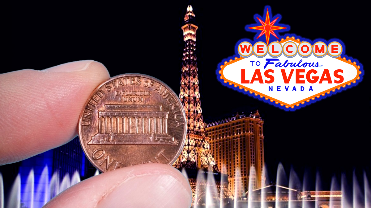 Hand Pinching a Penny With a Las Vegas Background