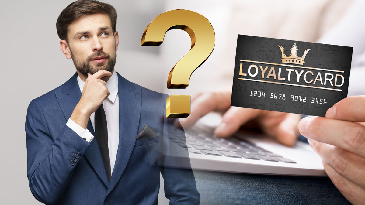 Man in Thought With A Loyalty Card In Front Of A Computer