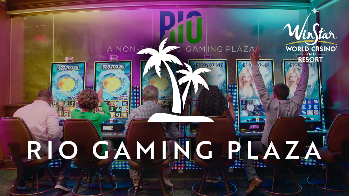 People Sitting at A Row Of Slot Machines in the Rio Gaming Plaza at Winstar World Casino
