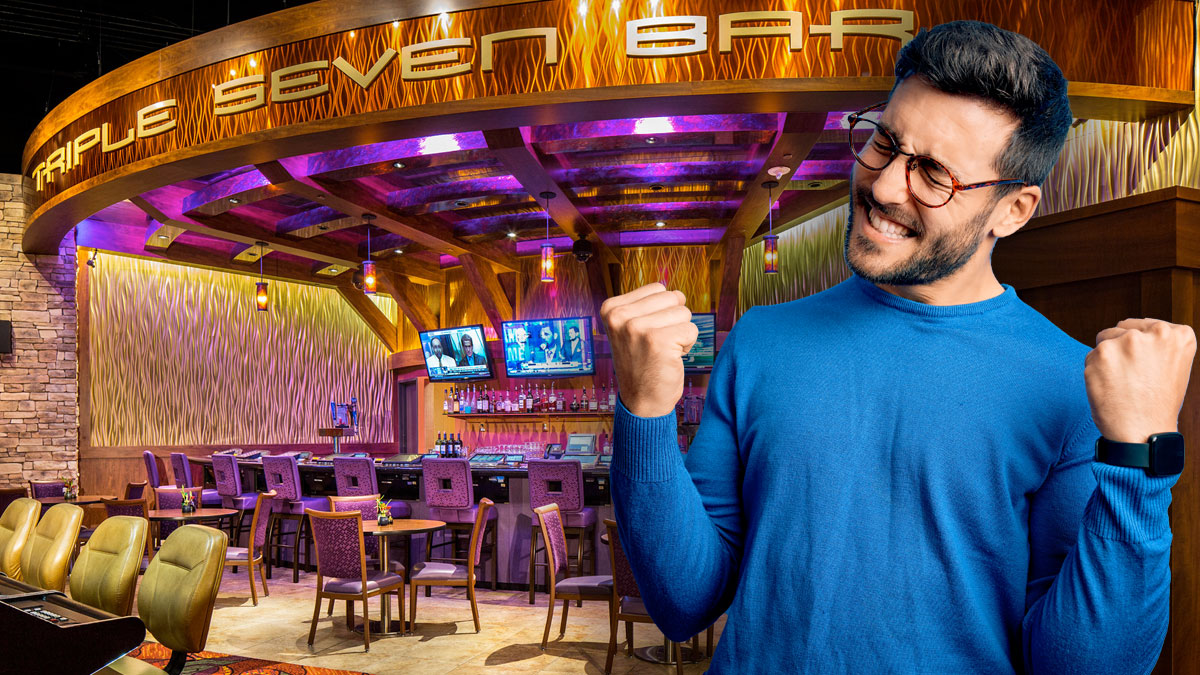 Man With Hands up in Front of the Triple Seven Bar at Wild Card Saloon Casino