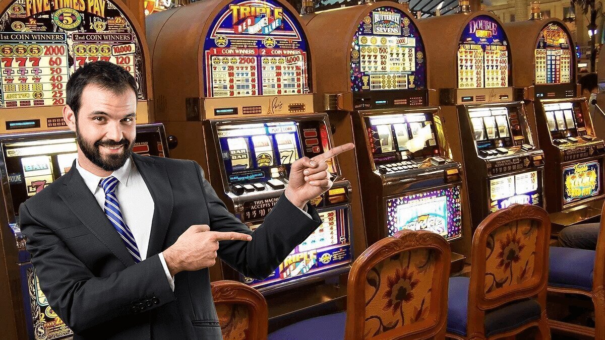 Businessman pointing at a row of slot machines